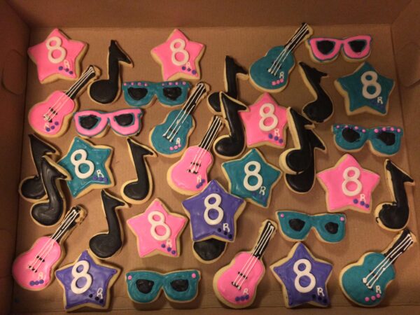 A box of cookies decorated with musical instruments.