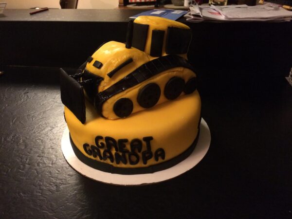 A cake with a bulldozer on it.