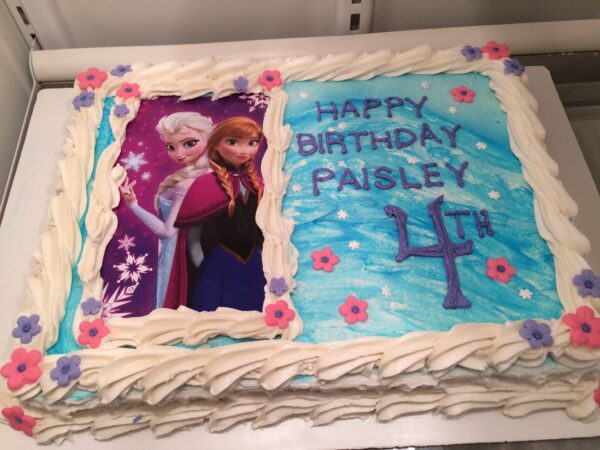 A frozen birthday cake with a picture of elsa and anna.