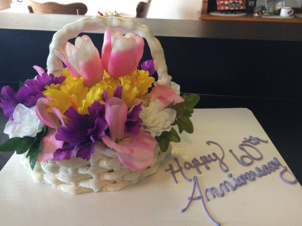 A cake with flowers in a basket.