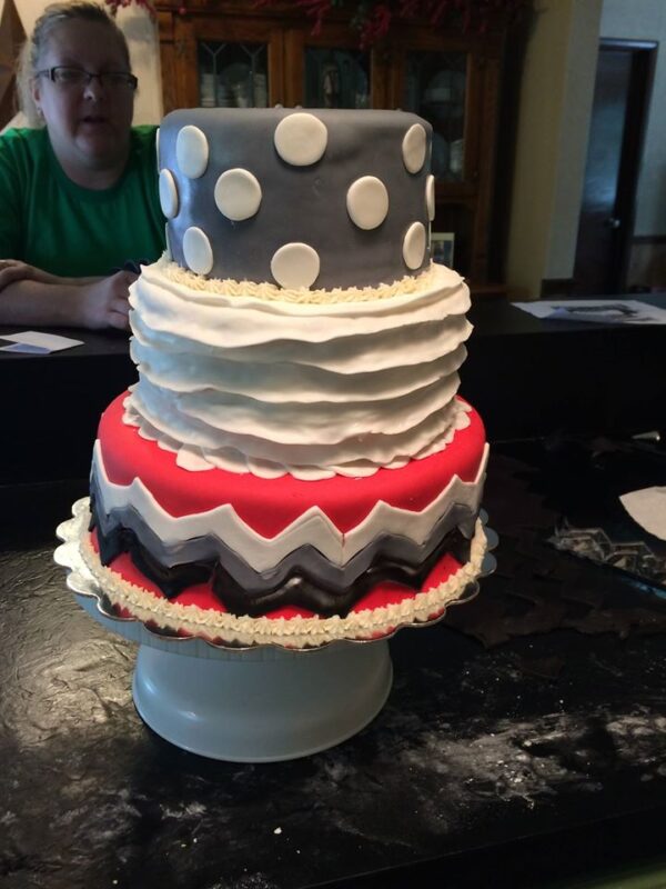 A three tier cake with a polka dot pattern.