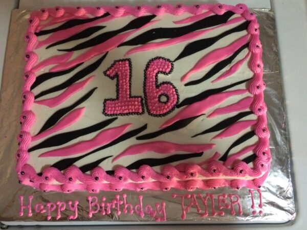 A zebra print birthday cake with the number 16 on it.