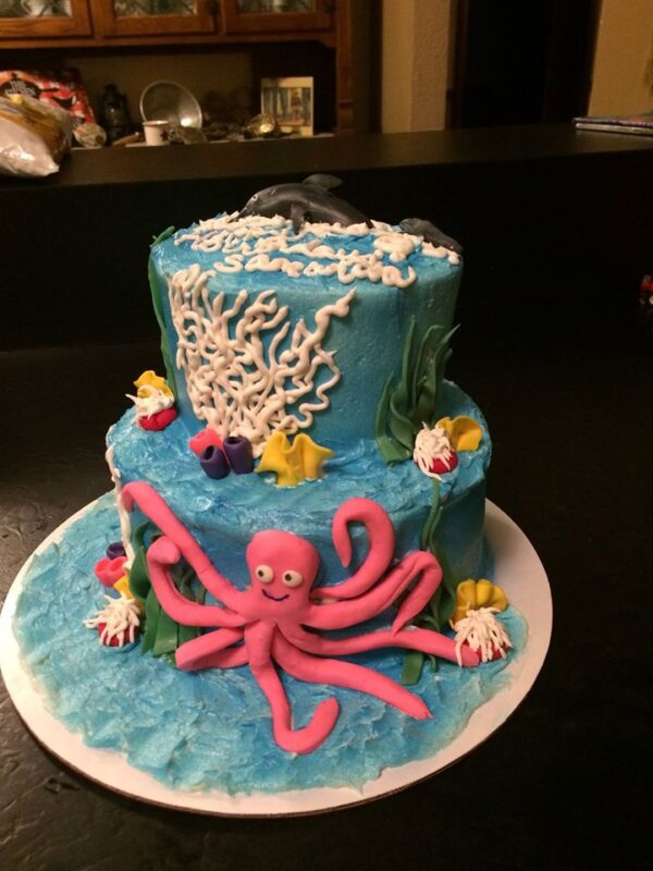 A cake with an octopus on top.