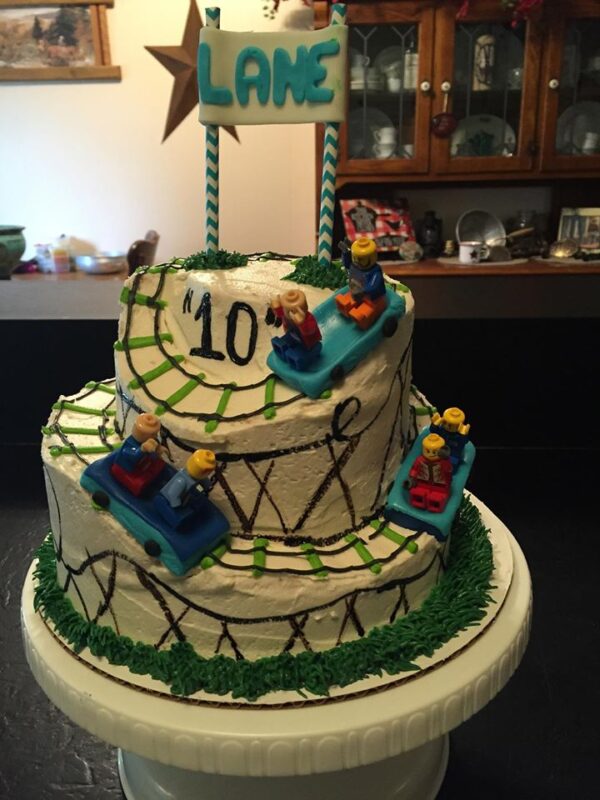 A cake with a lego race track on top.