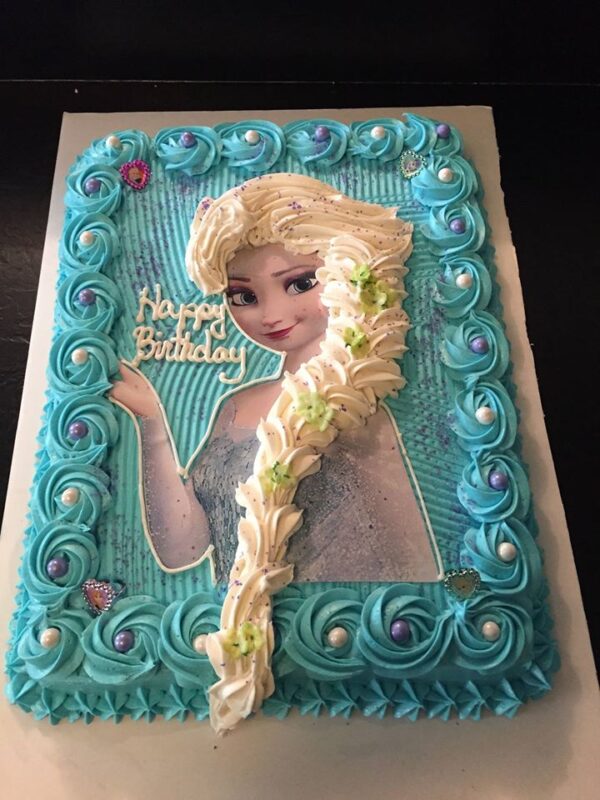 A frozen birthday cake with elsa's face on it.