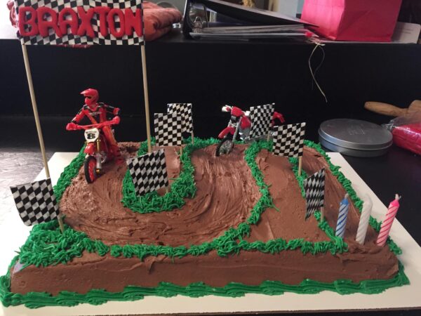 A birthday cake with a dirt bike on it.