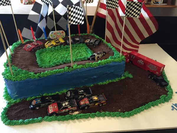 A cake with a race track on it.