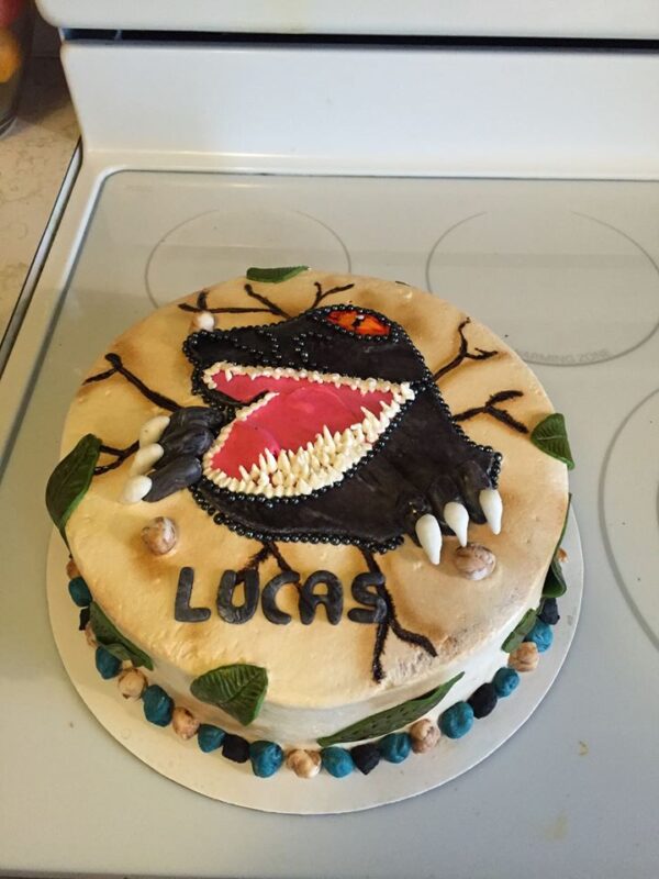 A cake with a dragon on top of it.