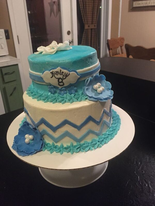 A blue and white chevron cake on top of a table.