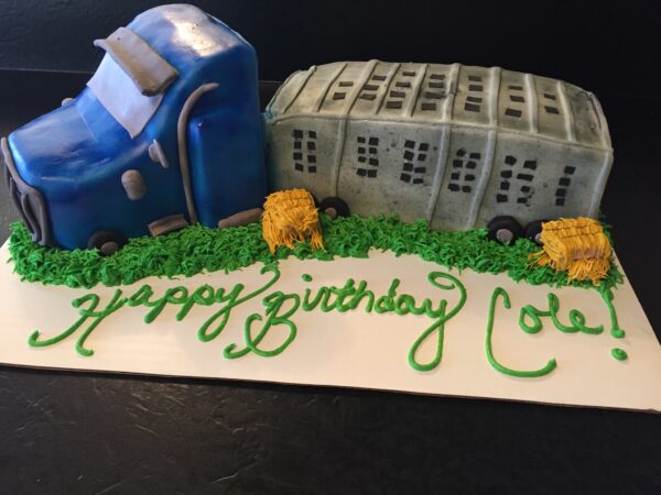 A cake with a tractor and a truck on it.