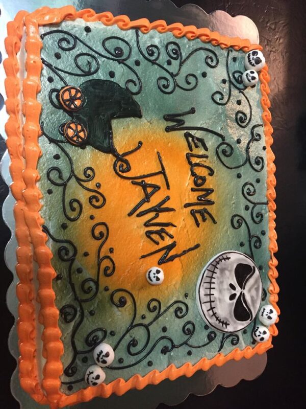 A cake with skeletons and jack-o-lanterns on it.