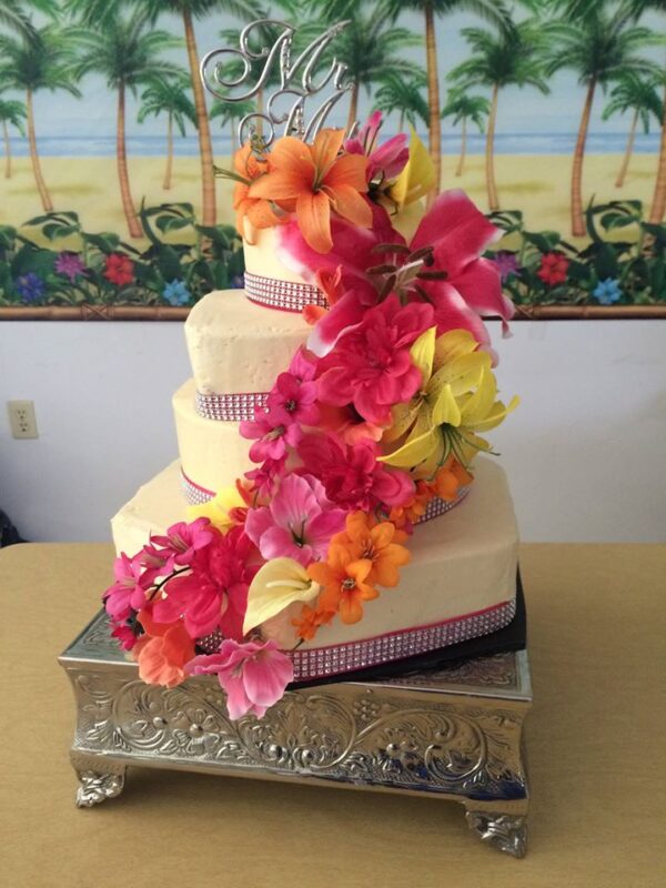 A three tier cake decorated with colorful flowers.