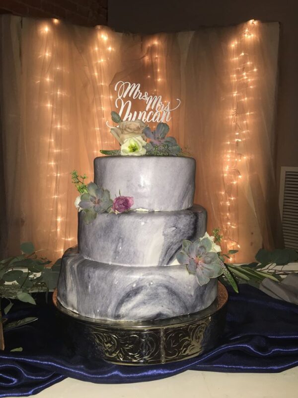 A three tier cake on a table.