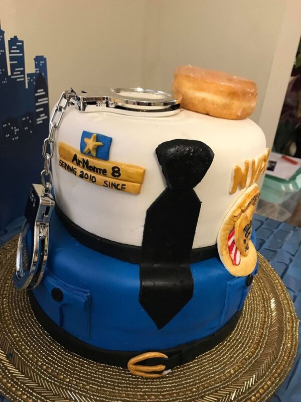 A cake decorated like a police officer's uniform.