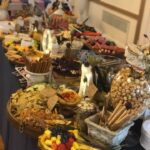 A buffet table with a lot of food on it.