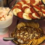 A table with a variety of food on it.