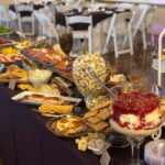 A buffet table with a variety of food on it.