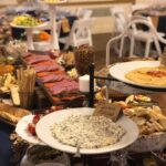 A buffet table with a variety of food on it.