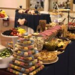 A buffet table with a variety of food on it.