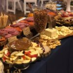 A buffet with a variety of snacks and dips.