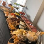 A buffet with a variety of foods on a table.