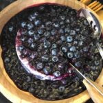 Blueberry cheesecake in a wooden bowl.