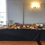 A buffet table with a lot of food on it.