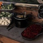 A buffet table with a variety of food on it.