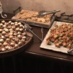 A buffet with a variety of food on a table.