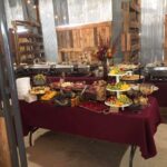 A buffet is set up in a barn.