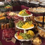 A buffet table with a variety of food on it.