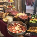 A buffet table with a variety of food on it.