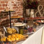 A buffet table with a variety of food on it.