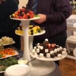 A man standing in front of a buffet of food.