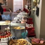 A buffet table with a lot of food on it.