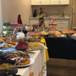 A buffet table with a lot of food on it.