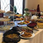 A buffet table with a lot of food on it.