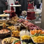 A buffet table with a lot of food on it.