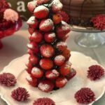 A chocolate strawberry tower on a plate.