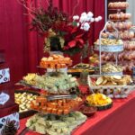 A table full of food and desserts at a christmas party.