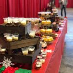 A table of desserts on a red tablecloth.