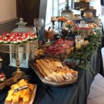 A buffet table with a lot of food on it.