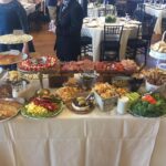 A table full of food at a wedding reception.