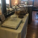 A table with a cake and desserts on it.