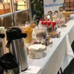 A table full of food and drinks at an event.