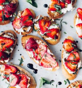 Strawberries and goat cheese crostini with balsamic vinaigrette.