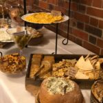 A buffet table with a variety of food on it.