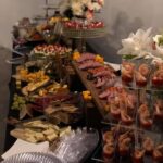 A buffet table with a variety of food on it.