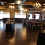 A large banquet room with tables and chairs.