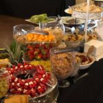 A buffet table with a variety of food on it.